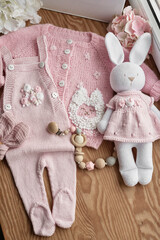 Baby knitted clothes and toys. Handmade knitted clothes with embroidery.
