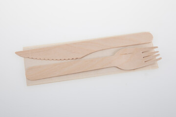wood tableware wooden fork knife and recycled napkin recyclable on white background