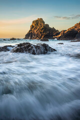 Beautiful dawn landscape over Kynance Cove in Cornwall England with vibrant sky and beautiful turquoise ocean