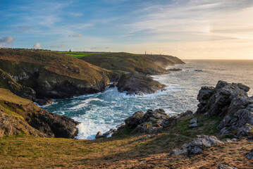 Stunning sunset landscape image of Cornwall cliff coastline with tin mines in background viewed from Pendeen Lighthouse headland