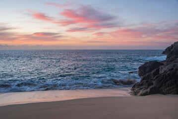 Majestic sunrise landscape at Porthcurno beach in Cornwall England with stunning colours and atmosphere