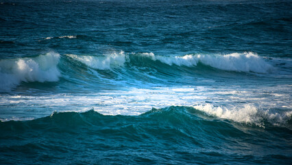 Obraz premium Large Powerful jade turquoise colored waves crashing at Sennen Cove in Cornwall during late sunset