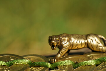 Tiger figurine with Chinese coins. A religious symbol. Feng shui figurines.