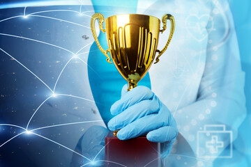 medical trophy, golden prize in doctor's hands on background of planet with international...
