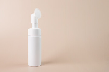 Face cleanser, Facial skin care, skincare bottle, Cosmetics foam pump container on a beige natural background