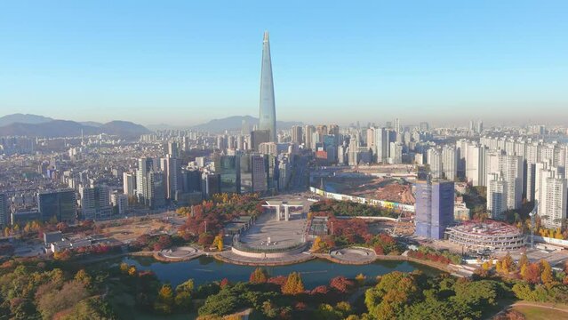 Seoul: Aerial view of capital city of South Korea, Olympic Park, skyline with modern high-rise buildings and Lotte World Tower in autumn, clear blue sky - landscape panorama of East Asia from above