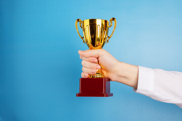 business award, corporate cup in the hand of the winner of the competition