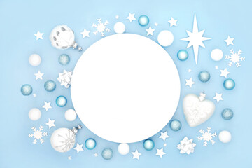 Christmas dinner plate table place setting with frosted decorations. Abstract design for Xmas festive holiday season and New Year. On pastel blue background.