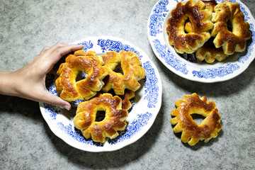hand eating a homemade algerian cookies ring named 