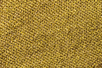 Yellow fabric texture. Closeup textile background. Apparel clothes. Casual wear. Knit pattern. Warm winter fiber material. Cotton background. Plain cloth background.