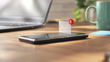 smart phone mobile receiving mail message,email notification allarm appears on smartphone screen on desk table - Powered by Adobe