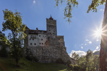 Fototapeta na wymiar Despite the magnificence of the surrounding nature, even on a bright sunny day, Bran castle remains a majestic but gloomy reminder of medieval tragedies, Brasov, Romania