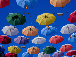 Colorful and beautiful umbrellas hanging in the city street decoration