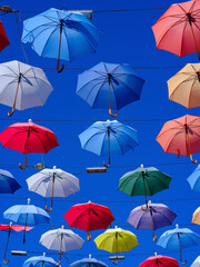 Colorful and beautiful umbrellas hanging in the city street decoration
