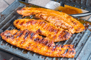 Grilling bacon on electric grill.