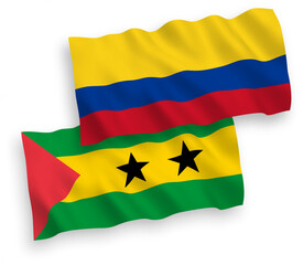 Obraz premium National vector fabric wave flags of Saint Thomas and Prince and Colombia isolated on white background. 1 to 2 proportion.