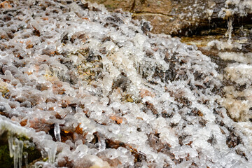 Icy rocks, ice formation on cold rocks from small water drops. Frozen water on rocks.