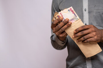 man holding and envelope containing money