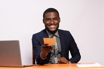 businessman giving someone an envelope