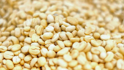Closeup and crop raw coffee beans and blurred background.