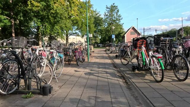 Low altitude aeral drone footage moving through bicycle parking place first person view showing parked bicycles on the left and right side narrow flight path 4k high resolution professional equipment
