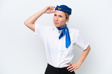 Airplane blonde stewardess woman isolated on white background having doubts and with confuse face expression