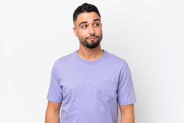 Fototapeta premium Young Arab handsome man isolated on white background making doubts gesture looking side