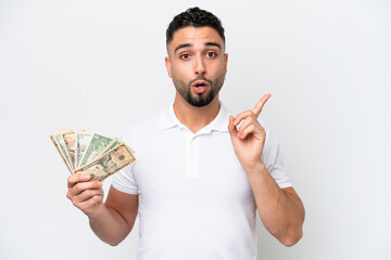 Young Arab man taking a lot of money isolated on white background intending to realizes the solution while lifting a finger up