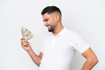 Young Arab man taking a lot of money isolated on white background suffering from backache for having made an effort