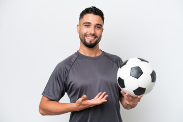 Arab young football player man isolated on white background extending hands to the side for inviting to come