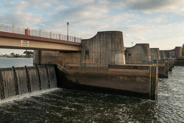 Dam (weir) of a hydro power plant along Weser river (Bremen). Water cascading down a barrage.  Weir called 