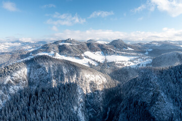 Carpathian, Romania, 2021-12-28. Romanian mountain illuminated by the sun with conifers under the snow.