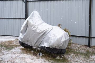 Motorcycle storage under an awning in winter outdoor. Protective awning, under the snow