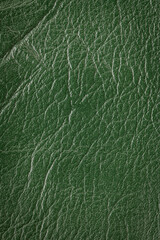 Green artificial or synthetic leather background with neat texture and copy space