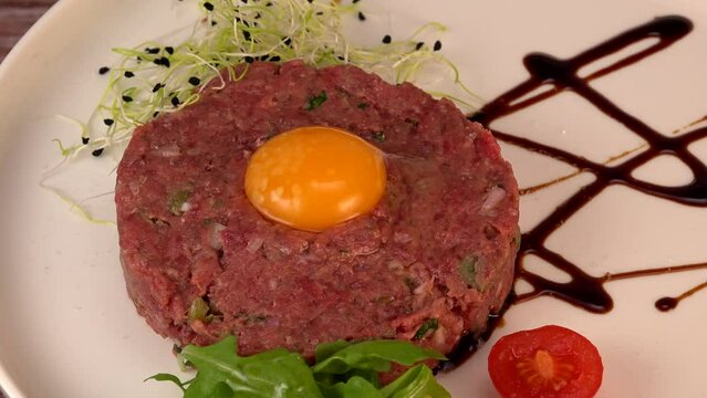 Steak Tartare with vegetables salad and french fries on dish. High quality 4k footage