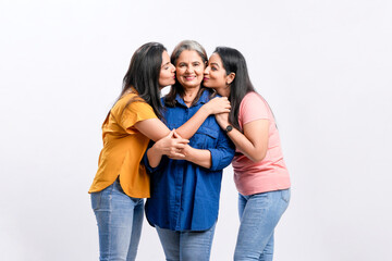 Three indian women giving expression together on white background.