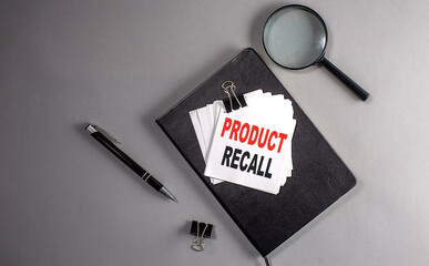 PRODUCT RECALL Text on a sticky on black notebook , business concept