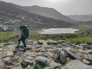 Woman hiking the long distance hike in Corsica called the GR20. A long hike with a heavy backpack....