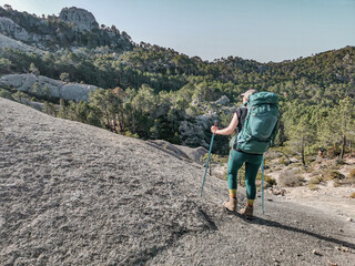 Woman hiking the long distance hike in Corsica called the GR20. A long hike with a heavy backpack....