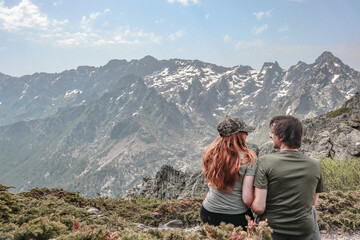 Naklejka premium Couple enjoying the mountain views during the GR20 hike in Corsica.
