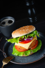 Fresh tasty burger on dark background