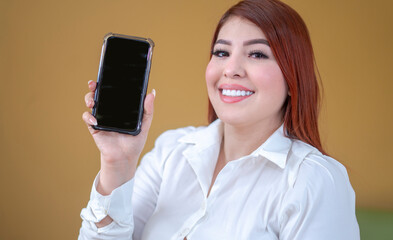 happy and beautiful woman on her cell phone, searching, looking and taking a photo, making a selfie