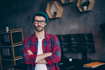 Photo of happy confident freelancer wear hat glasses arms folded coding new application indoors...
