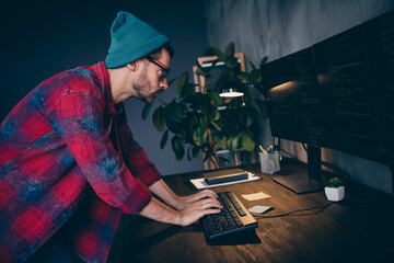 Photo of clever busy freelancer wear hat glasses typing code modern gadget indoors workplace workstation loft