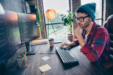 Photo of smart intelligent coder dressed hat glasses writing application software modern gadget...