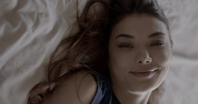 Portrait of a pretty young woman in the bed