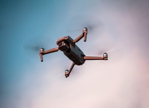 drone flying in the sky at sunset