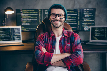 Photo of good mood happy coder dressed hat glasses smiling arms folded indoors workplace...