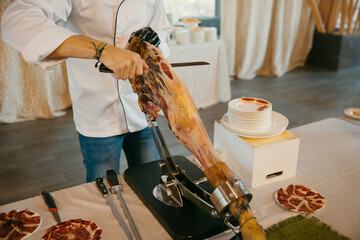 close up view of a professional ham cutter while cutting the ham and preparing the portions