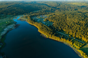 drone view of the forest and the river, curving shore and coniferous trees